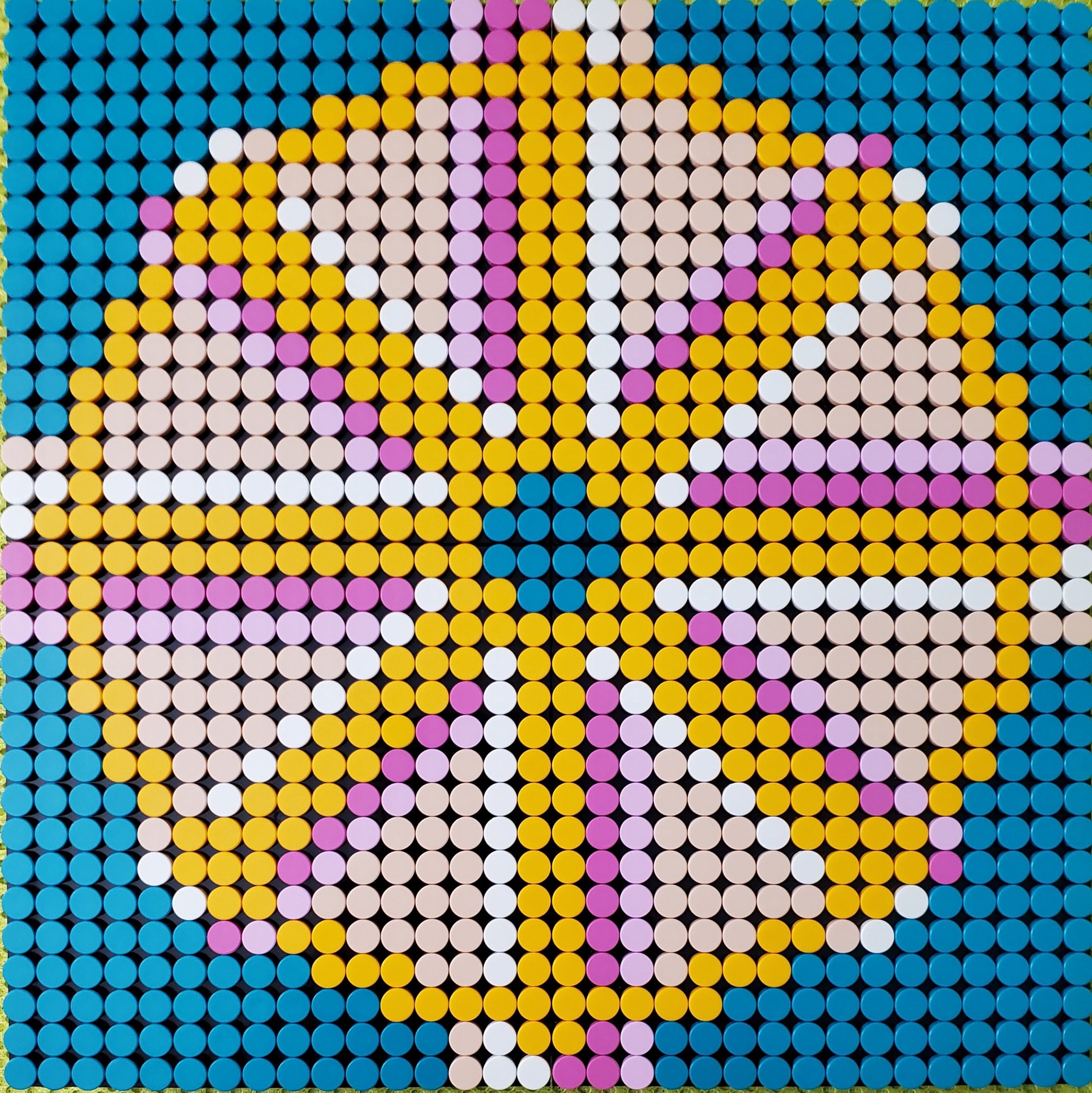Picture of a Dharma wheel in yellow, shades of pink, white on a blue background
